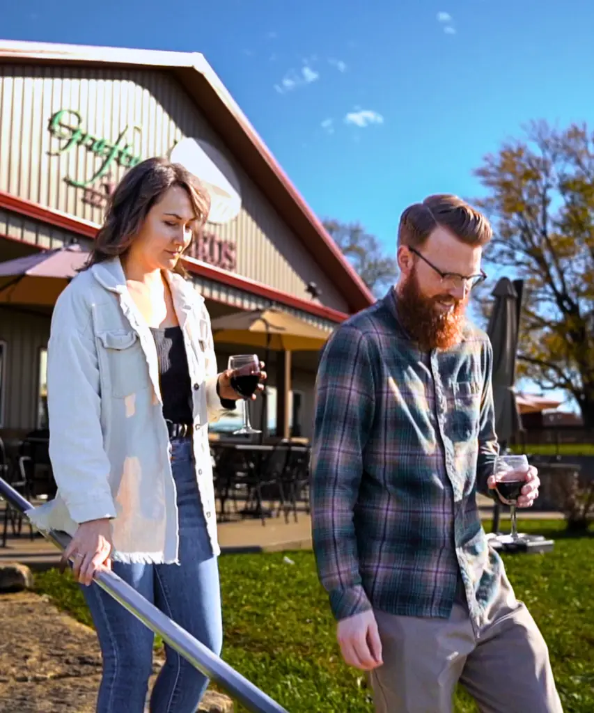 Couple walking down the front steps of The Vineyards at The Grafton Winery & Vineyards located in Illinois